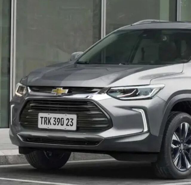 Carro SUV prata parado na diagonal.