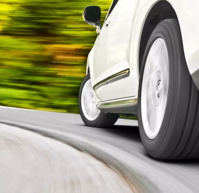 Carro branco em alta velocidade com suas rodas.